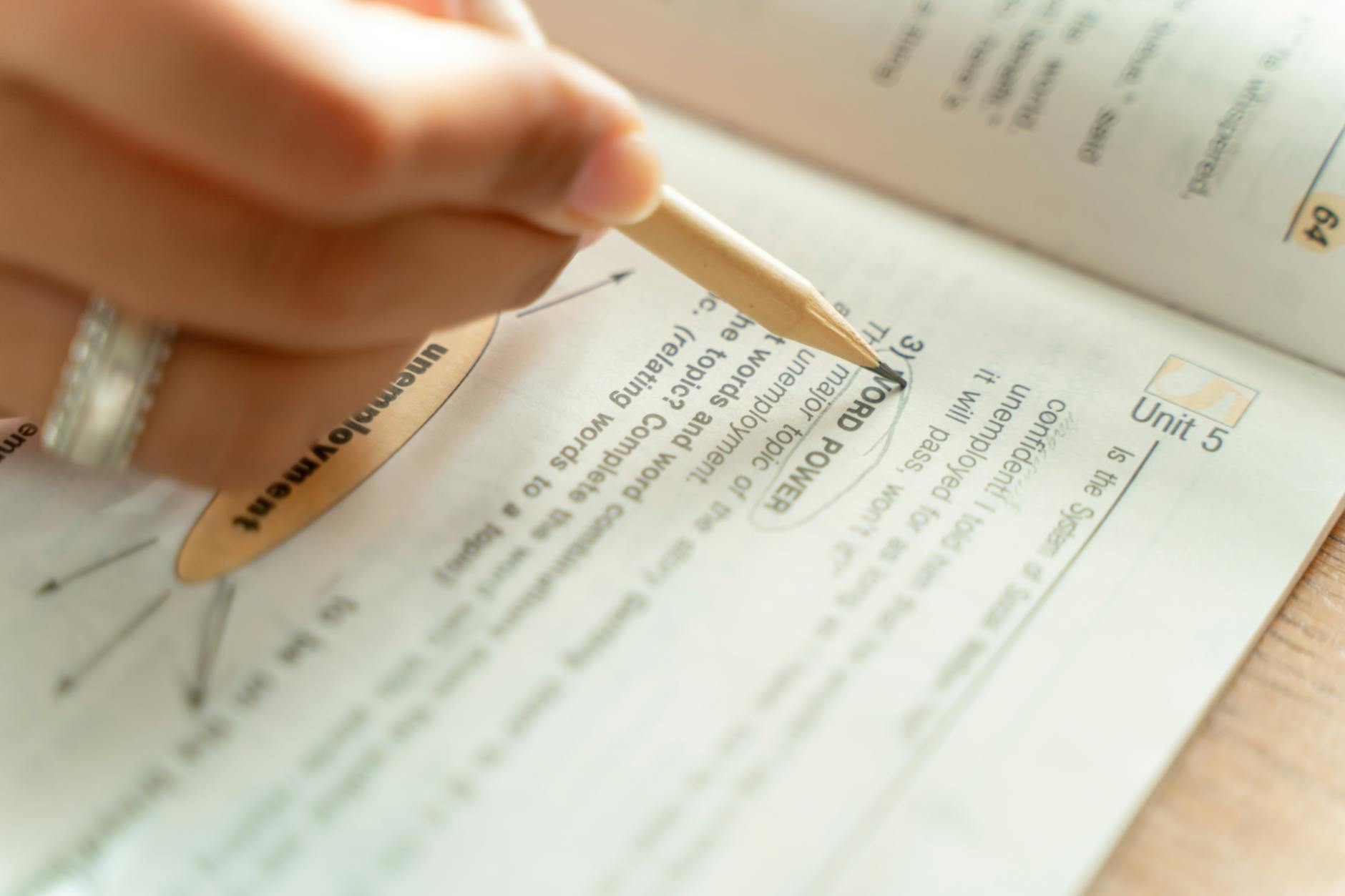 A close-up of a student preparing notes for a debate, illustrating the preparation and critical thinking involved. — deb…